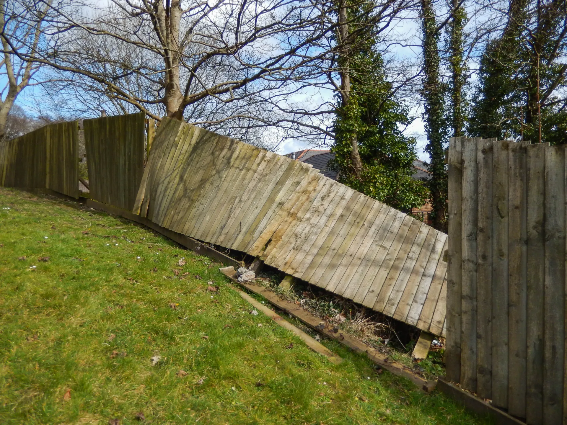 A dilapidated, leaning, or rotting wood fence demonstrating the core problem needing replacement in the local area